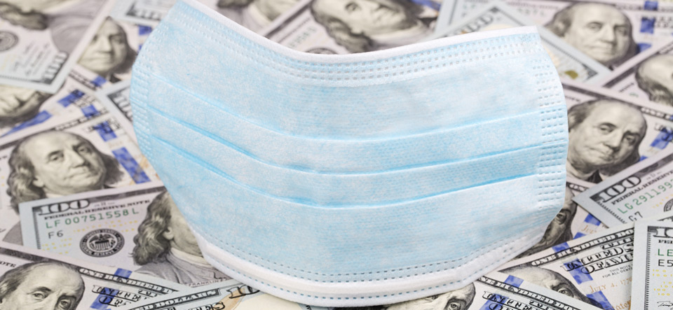 Personal protection medical mask on top of US dollars