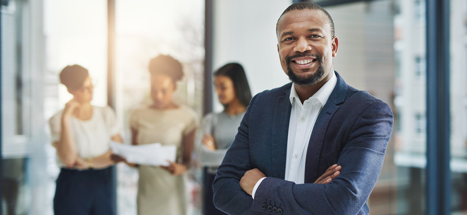 Cropped shot of a group of businesspeople standing in the office