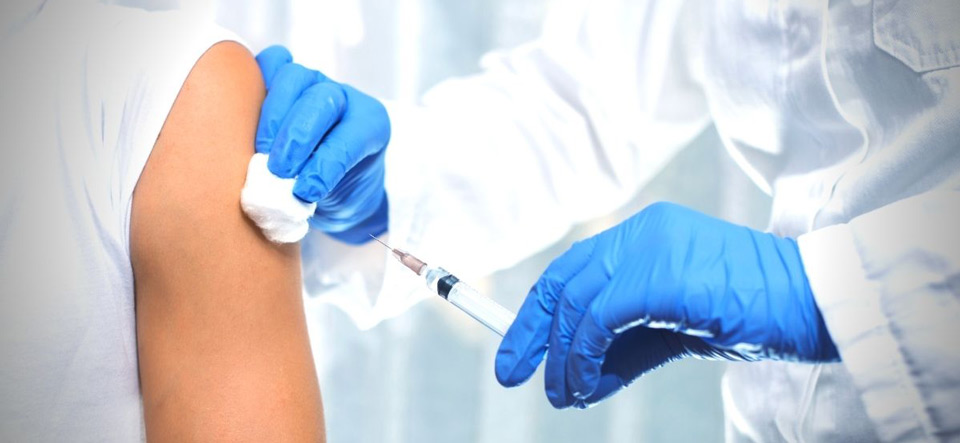 Doctor administering COVID-19 vaccine to a patient's arm