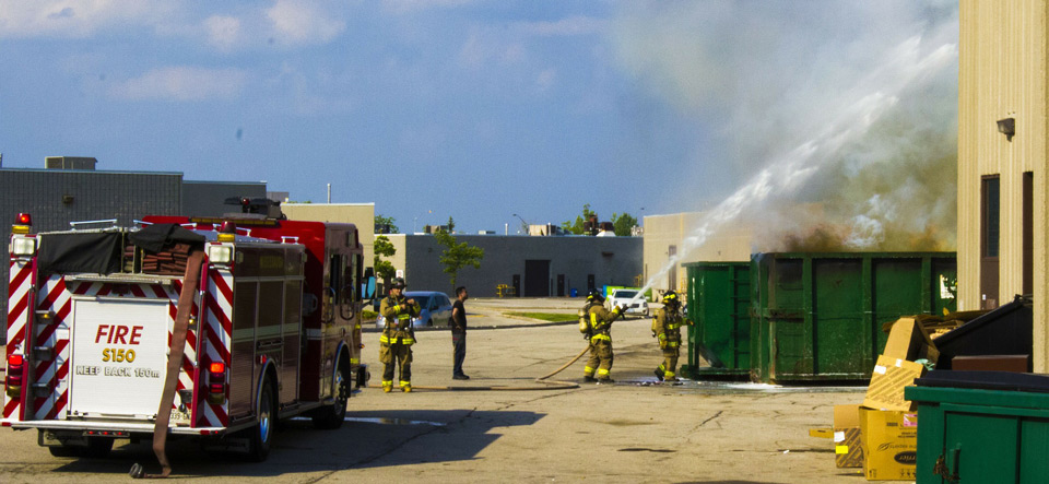 Fire fighters spraying a building