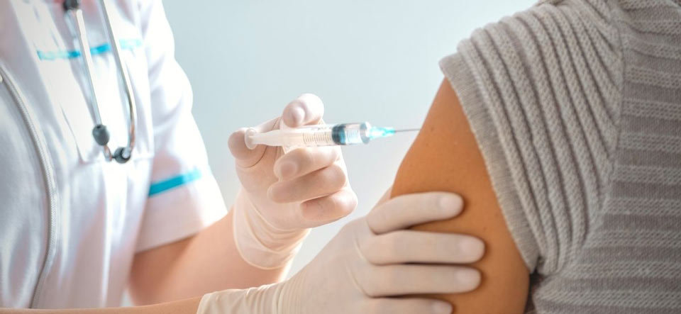 Patient receiving a vaccine shot in the arm