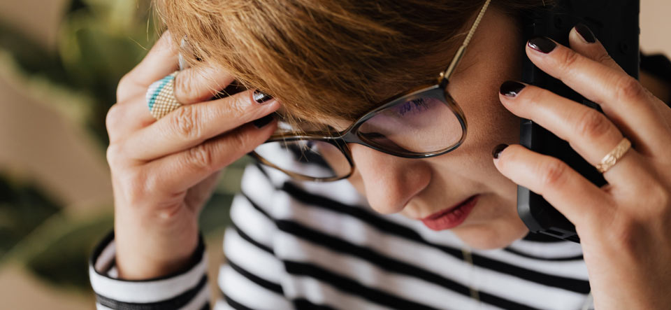 Woman looking stressed on a phone call