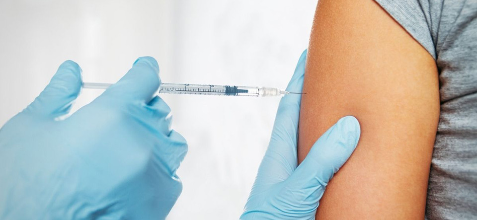 Patient receiving a vaccine shot in the arm