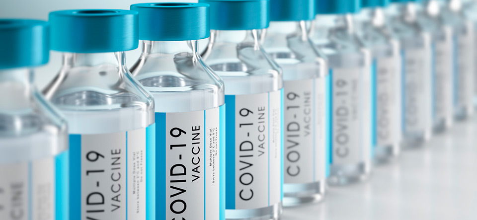 Row Covid-19 or Coronavirus vaccine flasks on white background