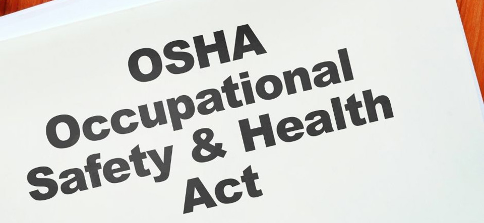 Piece of paper that reads OSHA Occupational Safety and Health Act on a tabletop