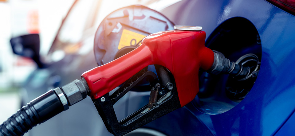 Car fueling at gas station. Refuel fill up with petrol gasoline. Petrol pump filling fuel nozzle in fuel tank of car at gas station. Petrol industry and service. Petrol price and oil crisis concept.