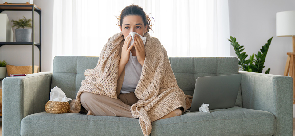 Ill upset girl is holding paper tissue and blowing nose. Virus symptom concept.