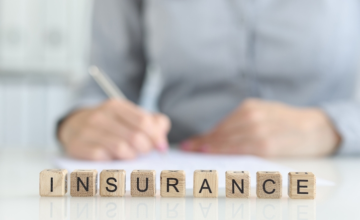 Insurance agent fills out insurance form in office. Medical and home insurance concept