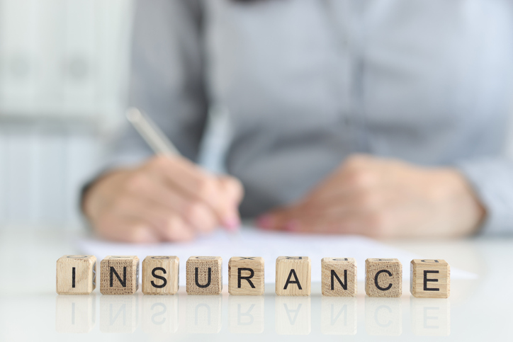 Insurance agent fills out insurance form in office. Medical and home insurance concept