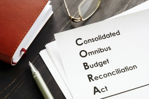 COBRA Consolidated Omnibus Budget Reconciliation Act on the desk.