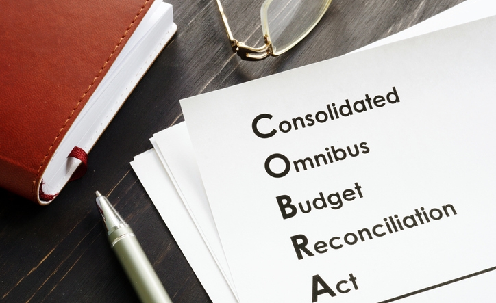 COBRA Consolidated Omnibus Budget Reconciliation Act on the desk.