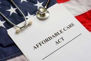 Affordable Care Act ACA, flag and a stethoscope.