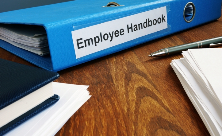 Employee Handbook manual in folder and documents.