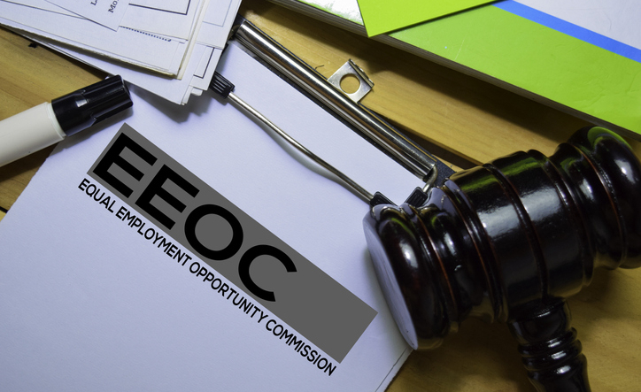 Equal Employment Opportunity Commission (EEOC) text on Document form and gavel isolated on office desk.