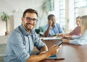 Portrait of a smart young businessman or teacher or student using a smartphone phone and texting in the office. Startup and succesful business concept