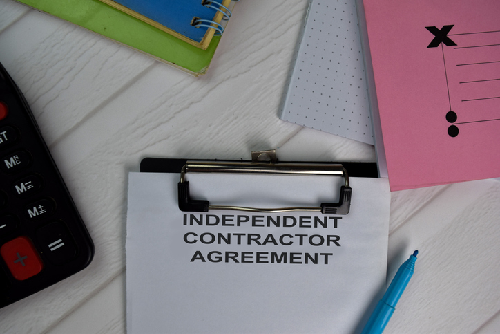 Independent Contract Agreement write on paperwork isolated on office desk.
