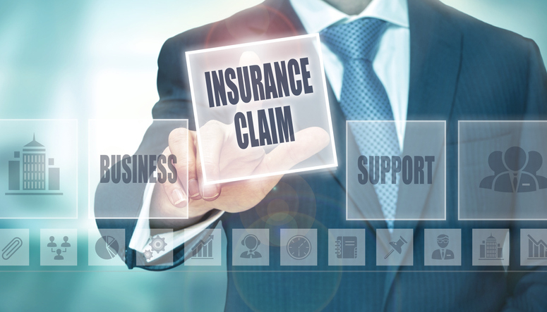 A businessman pressing an Insurance Claim button on a transparent screen.