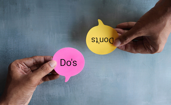 Top view image of hand holding speech bubble with text DO'S and DON'TS.