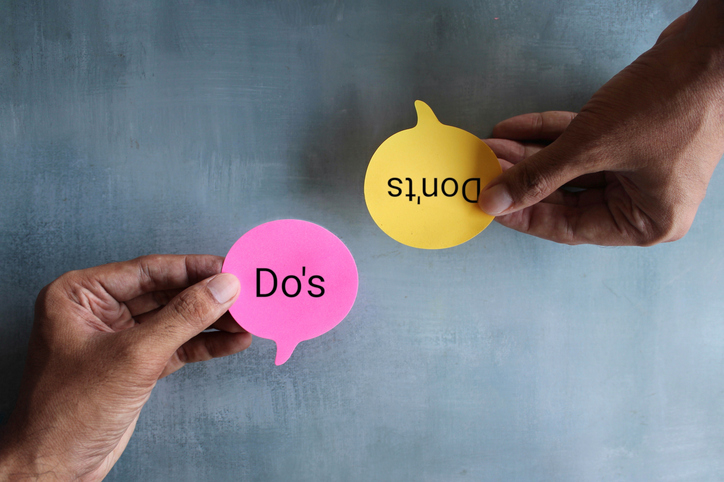 Top view image of hand holding speech bubble with text DO'S and DON'TS.