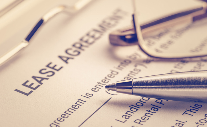 Business legal document concept : Pen and glasses on a lease agreement form. Lease agreement is a contract between a lessor and a lessee that allow lessee rights to use of a property owned by lessor